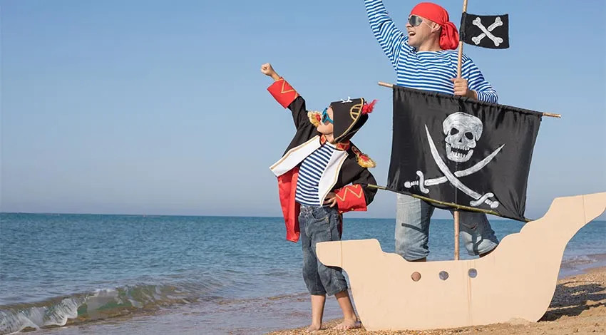 Ein Vater mit seinem Sohn als Piraten verkleidet an der Ostsee