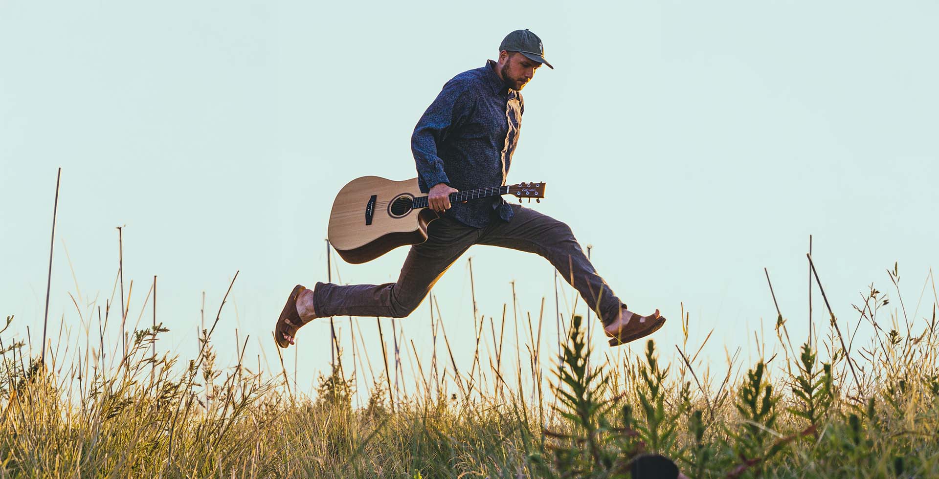 Musiker George Harris steht mit Gitarre in der Hand bereit für seinen Auftritt auf Fischland-Darß-Zingst.